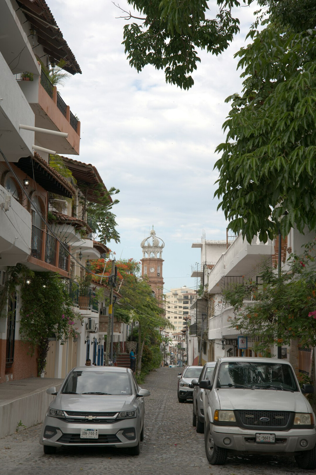 Historic cobblestone street with a lighthouse in Colonia del Sacramento